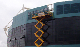 Men in cherry picker fixing black Louvres